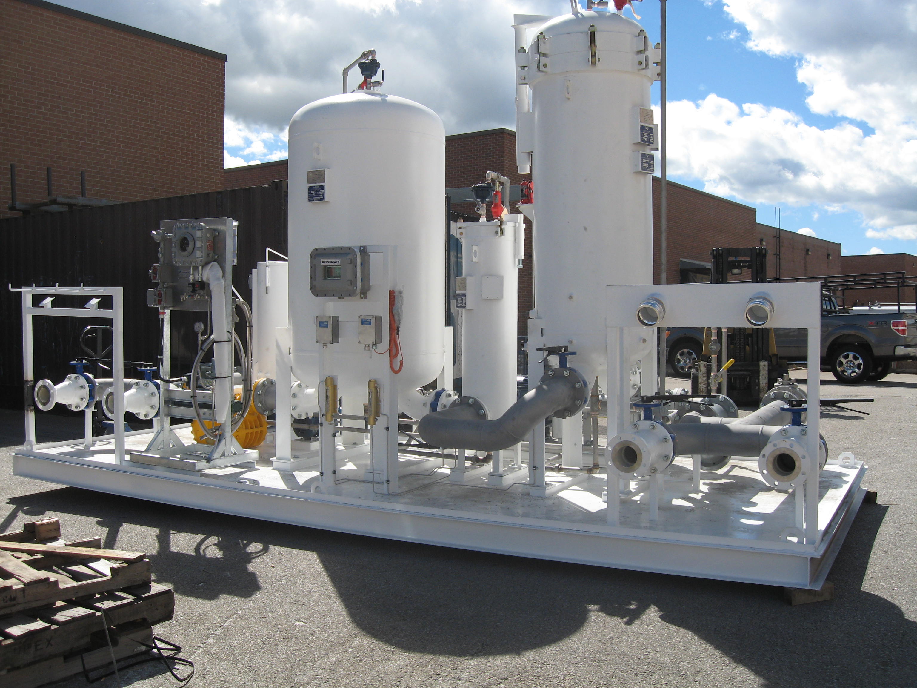 Aviation fuel filtration skid with vertical vessels and process piping