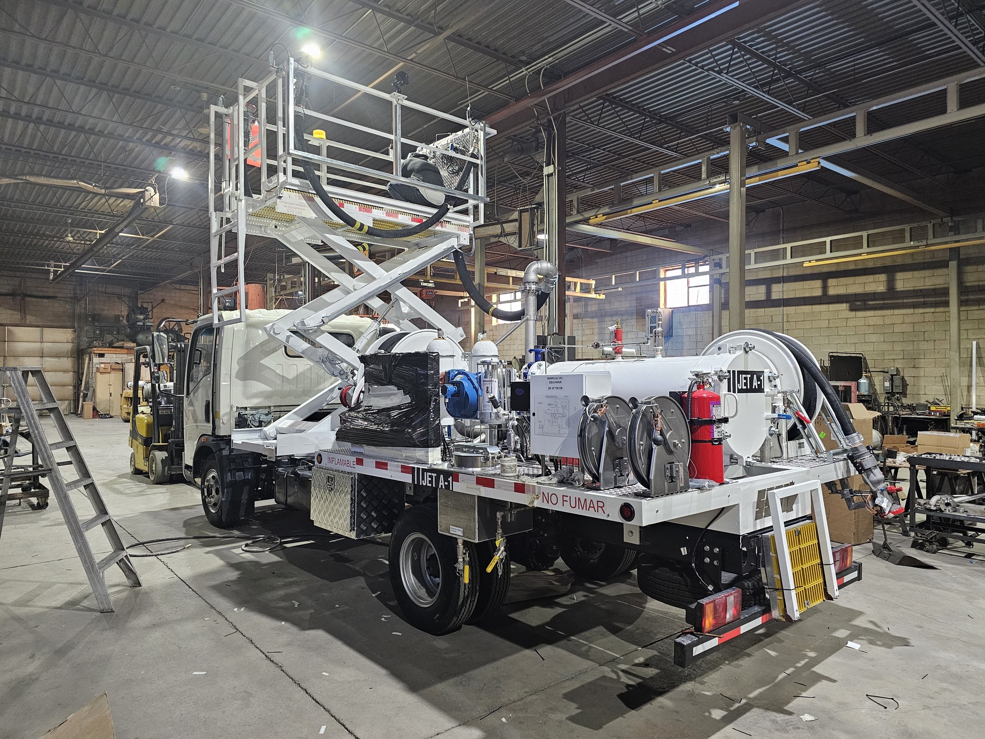 Lemico hydrant servicer with elevating fueling deck and hose reels