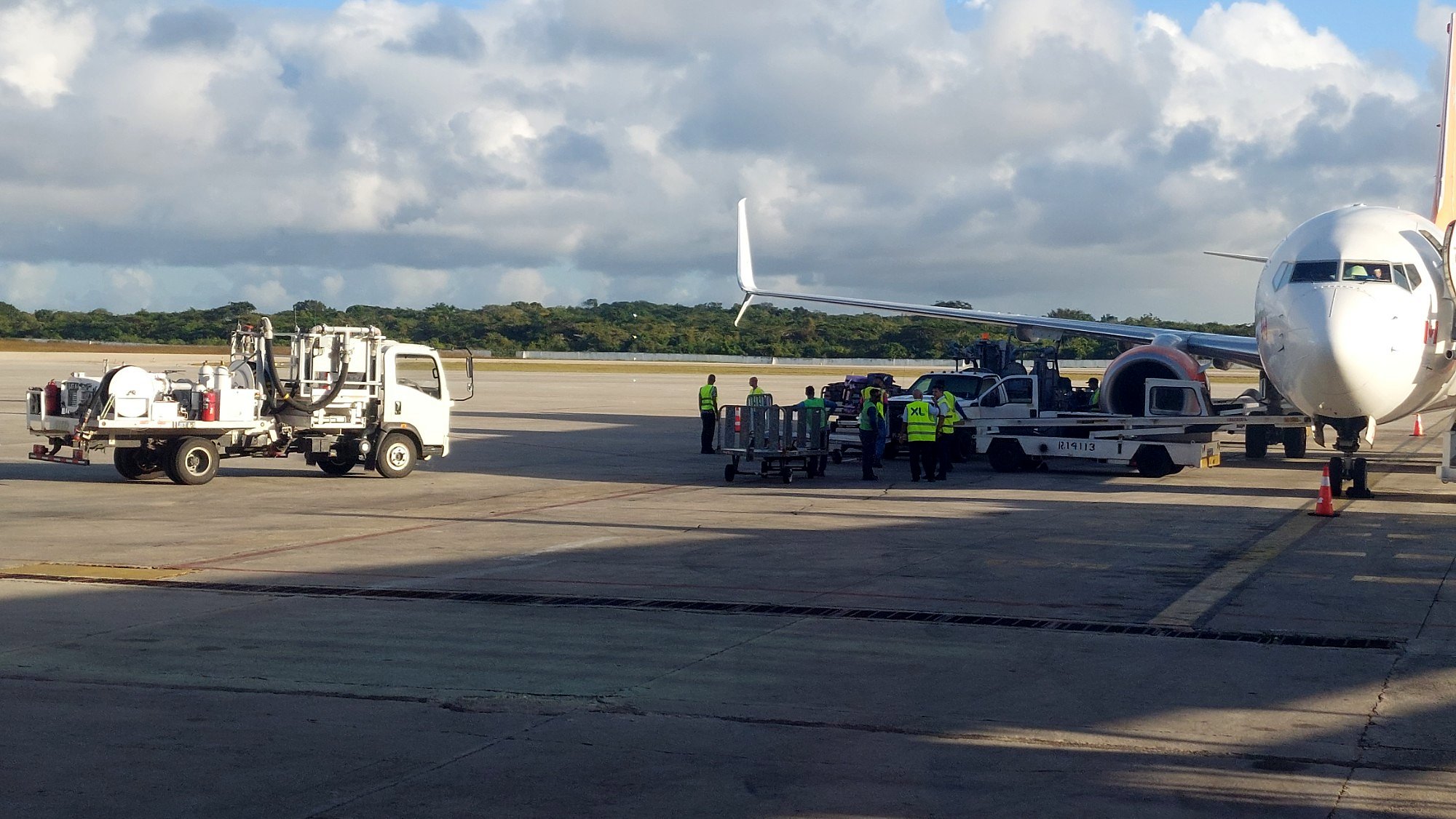 Fueling truck on the airport apron beside a commercial aircraft
