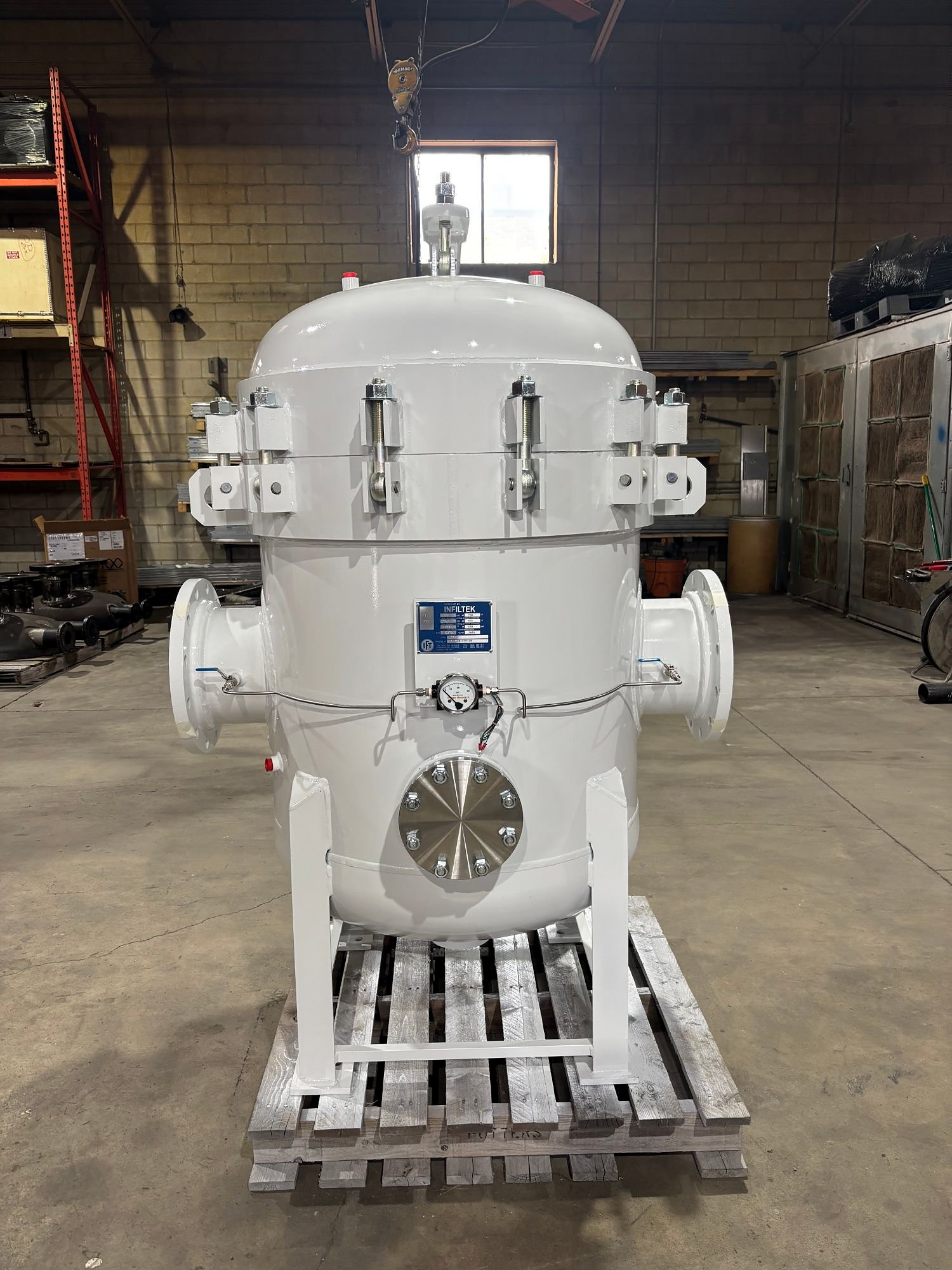 Vertical filter vessel with Infiltek nameplate and differential pressure gauge